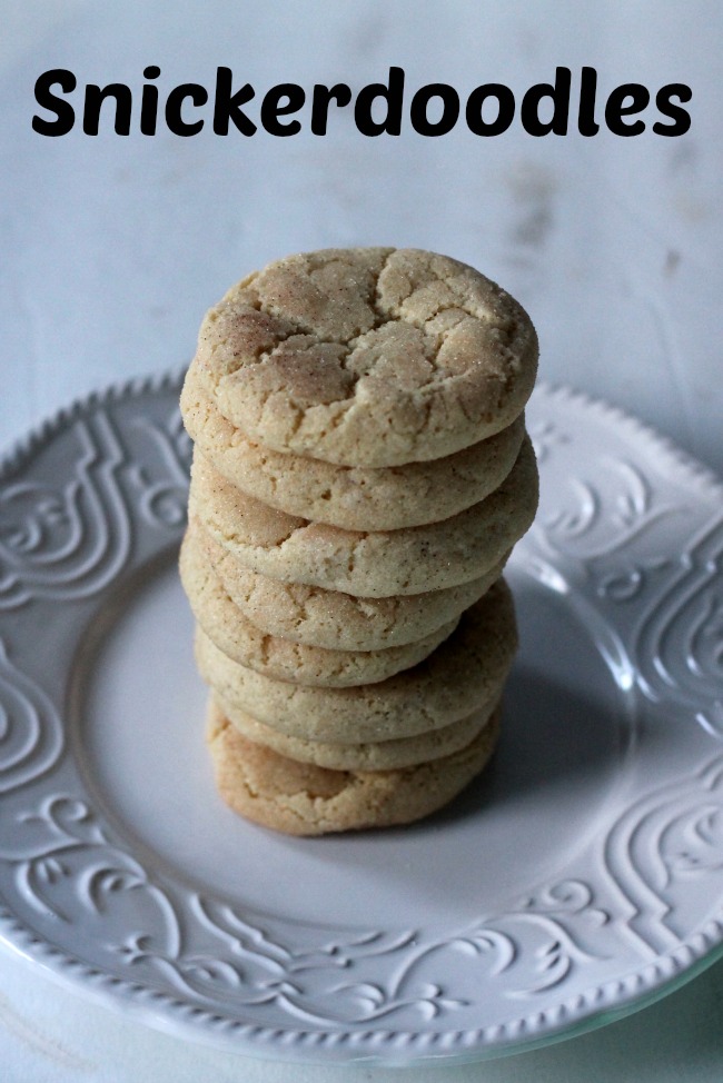 A stack of 8 snickerdoodles on a white plate. 